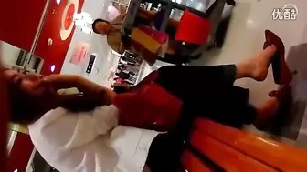 Cute Chinese Girl Dangles her Shoes at the Store