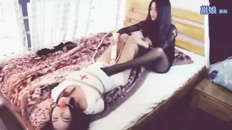 Young asian woman tied up by lesbian friend